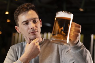 Close up man holding beer mug