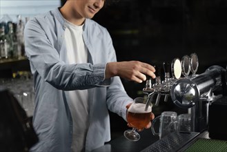 Close up man pouring beer glass