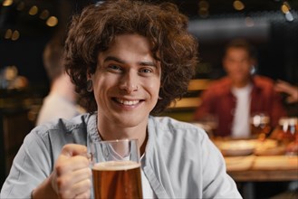 Close up smiley man holding beer mug pub