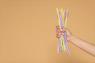 Close up woman hand with plastic straws