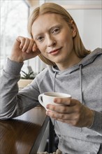 Close up woman holding cup 2