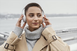 Close up woman with headphones outside