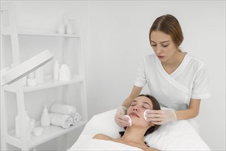 Female client salon face care routine with cleansing disks 4