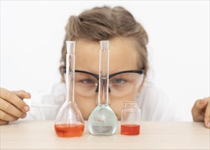 Girl doing chemistry experiments with test tubes