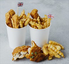 High angle fish chips paper cups with great britain flags