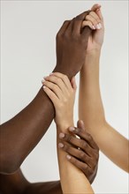 Interracial hands holding each other close up