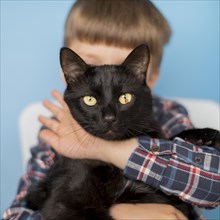 Little boy with black cat