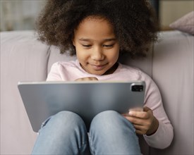 Little girl using tablet home