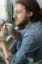 Man holding coffee cup close up