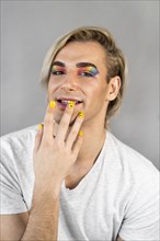 Man wearing make up cosmetics nail polish front view