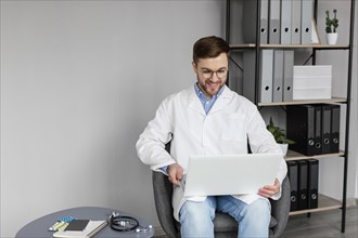 Medium shot doctor holding laptop