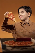 Medium shot kid holding pizza