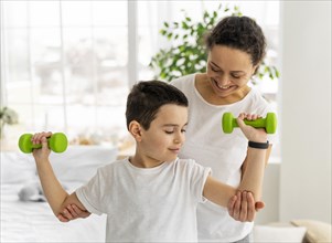 Medium shot kid training with dumbbells