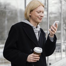 Medium shot woman checking phone
