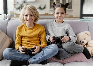 Siblings couch with joysticks playing