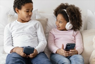 Siblings using mobiles