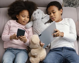 Siblings using tablet mobile home