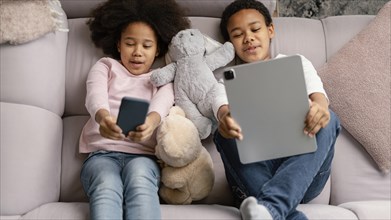 Siblings using tablet mobile home 5