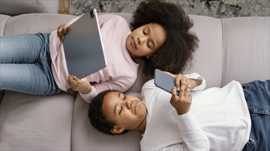 Siblings using tablet mobile home 6