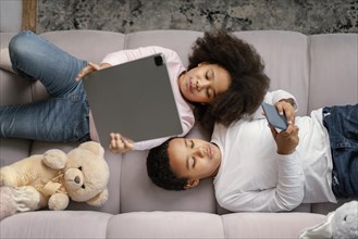 Siblings using tablet mobile home 7