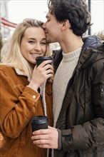 Young couple outdoor enjoying cup coffee 2