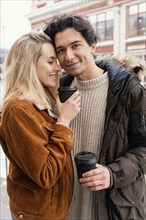 Young couple outdoor enjoying cup coffee 4