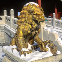 A golden lion statue in the Forbidden City