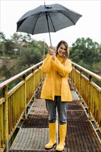Woman bridge holding umbrella