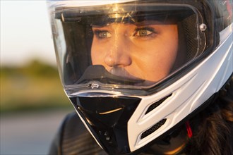 Woman riding her motorcycle with helmet