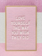 Pink motivational text board top view