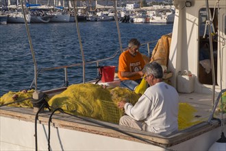 Fishermen mending nets