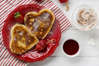 Top view heart shaped pancakes with strawberry