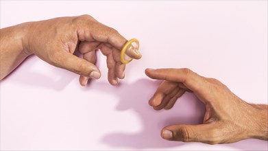 Close up man hands with transparent condom
