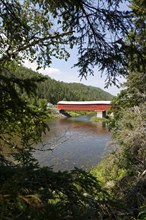 Red covered bridge over Matapedia River