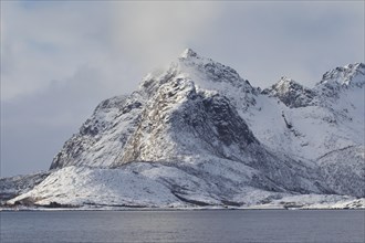 Snow covered mountains along the fjord Raftsund in winter