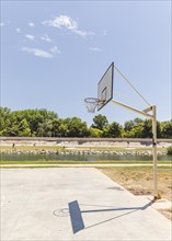Shadow empty basketball hoop outdoors court