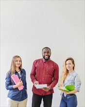 Successful students posing with notebooks