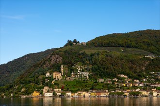 Beautiful Village Morcote witha Chucrh and Castle on Lake Lugano and Mountainscape with blue Clear sky in Morcote