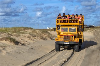Yellow 4x4 truck transporting tourists to the sand dunes and beach of Cabo Polonio National Park