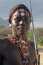 Portrait of Samburu warrior in traditional dress with spear