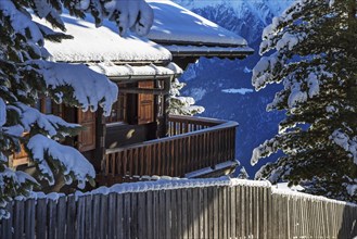 Swiss wooden chalet in the snow in winter in the Alps