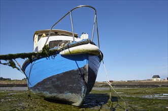 Old boat at low tide in the harbour of Paimpol