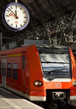 Local train at Frankfurt Central Station with station clock