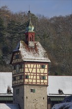 View of the snow-covered Josenturm tower in Gelbinger Gasse