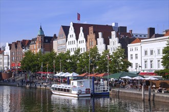 Historic houses and restaurants along the river Obertrave at the Hanseatic town Luebeck