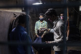 Workers colouring jeans in a textile factory