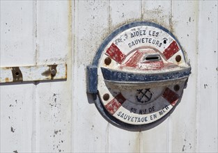 Donation box on the door to the historic lighthouse Phare du Cap Frehel with the inscription Help the rescuers