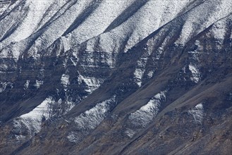 Snow covered eroded mountain slope at Adventdalen