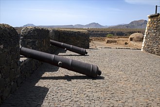 Old cannons and cistern in 16th century fortress Forte Real de Sao Filipe looking over the city Cidade Velha on the island Santiago
