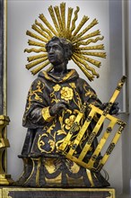 Figure of St Fides with grating